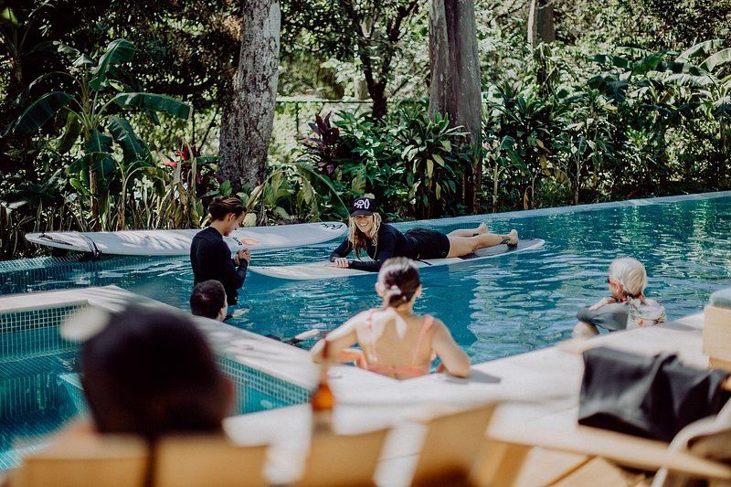 An instructor provides surf lessons at Surf Simply resort